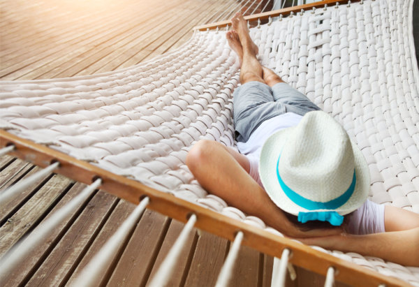 40901691 - lazy time. man in hat in a hammock on a summer day